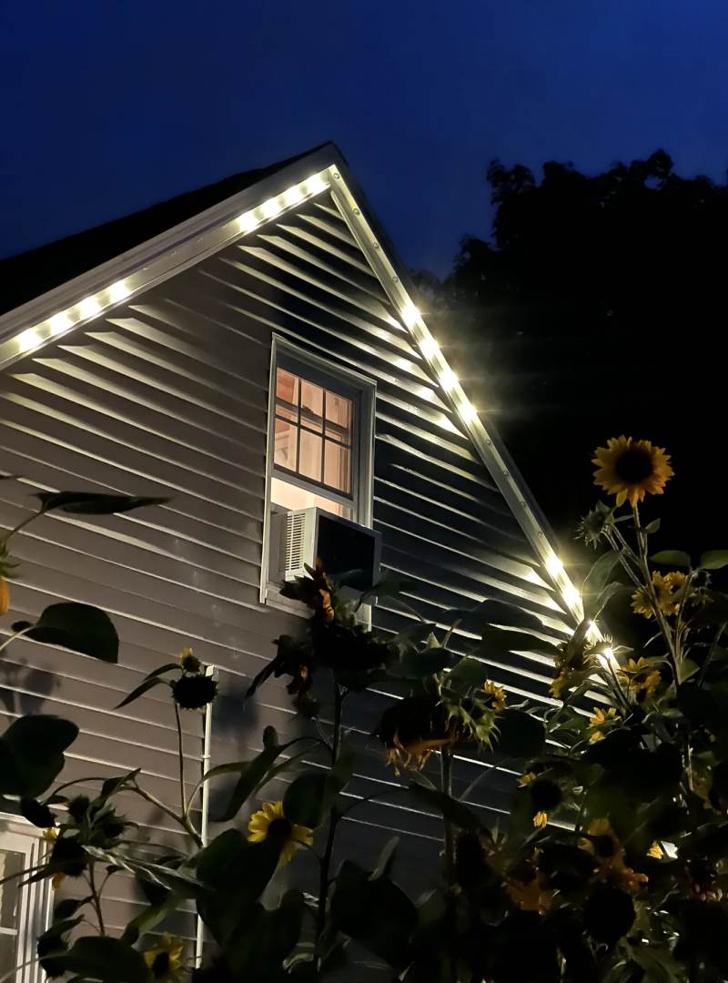 Warm white permanent LEDs illuminating a gable at night